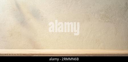 Sand-colored rough stone wall and wooden shelf in front of it. Kitchen texture background Stock Photo