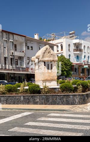 An old Lycian tomb on the roundabout in the the town centre of Kas, Turkey. Stock Photo