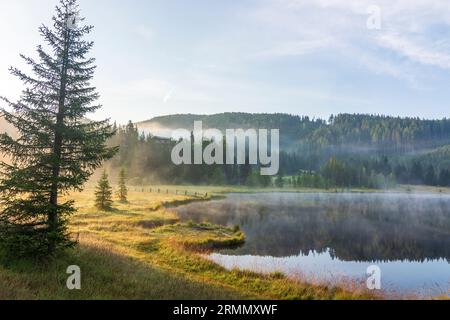 Tamsweg: morning mist on lake Prebersee in Lungau, Salzburg, Austria Stock Photo