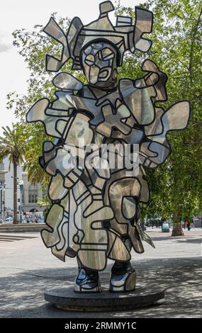 San Francisco, CA, USA - July 12, 2023: Closeup of La Chiffonniere statue. Green foliage of Embarcadero plaza. Coors truck and pedestrians in back Stock Photo