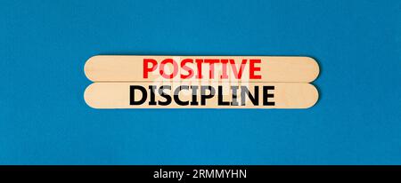 Positive discipline symbol. Concept words Positive discipline on beautiful wooden stick. Beautiful blue table blue background. Business psychology pos Stock Photo