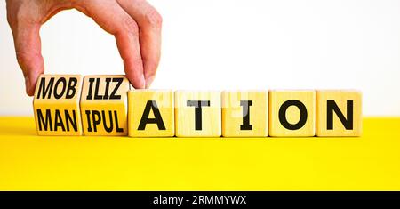 Mobilization or manipulation symbol. Concept words Mobilization Manipulation on wooden cubes. Beautiful white background. Psychologist hand. Psycholog Stock Photo