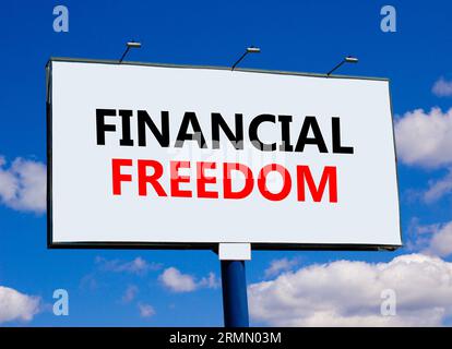 Financial freedom symbol. Concept words Financial freedom on beautiful big white billboard. Beautiful blue sky cloud background. Business financial fr Stock Photo