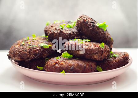 Fried minced cutlets served in a pile on a plate, typical eastern european homemade food, tasty dish Stock Photo