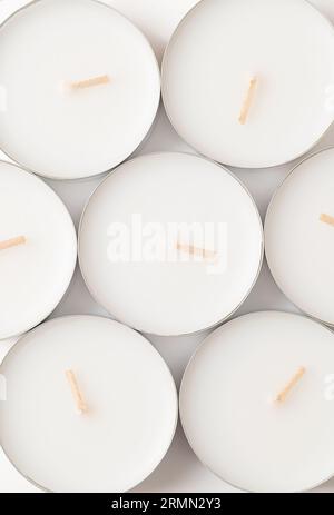 Group of large tealights, long-burning candles, from above. Also known as nightlights, tea lites, t-lites or t-candles in thin metal cups. Stock Photo