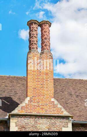 Duo of tall chimney pots at Queens' College, University of Cambridge, England. Stock Photo