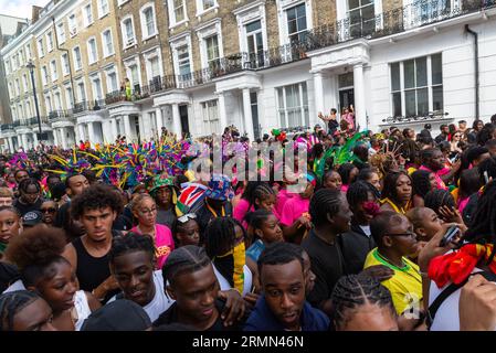 Crowds at the Notting Hill Carnival Grand Parade 2023, London, UK. Passing properties in Chepstow Road, W2 Stock Photo