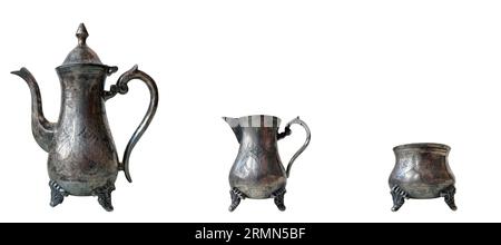 set old antique silver ware: coffee pot, creamer and sugar bowl isolated on white background Stock Photo
