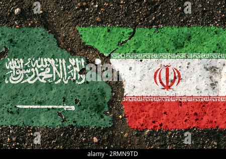 On the pavement there are images of the flags of Saudi Arabia and Iran, as a symbol of confrontation. Conceptual image. Stock Photo