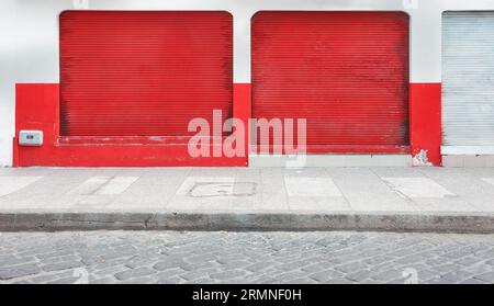 Street view of a shop with closed rolling shutters. Stock Photo