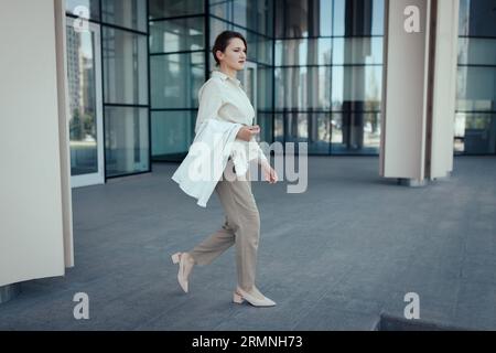 Confident stylish european 30 aged woman going from workplace Stock Photo
