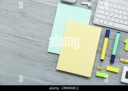 Keyboard with gadgets and different stationery on grey wooden background Stock Photo