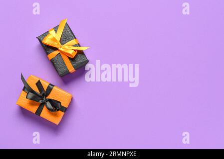 Gift boxes for Halloween celebration on purple background Stock Photo