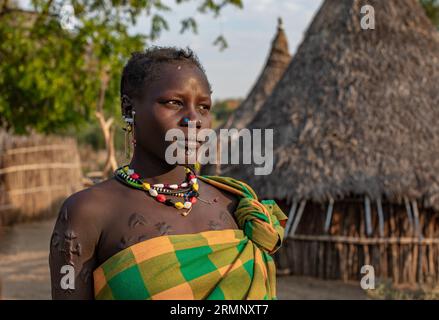 A woman from Larim tribe in her village Stock Photo
