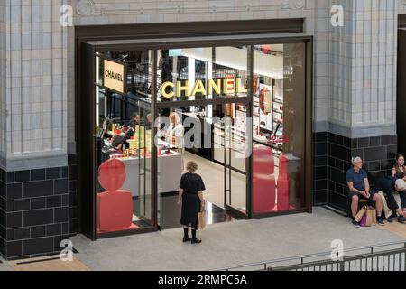 People shopping and browsing in a Chanel perfume store in the shopping centre at the heart of the refurbished Battersea Power Station. London, UK Stock Photo