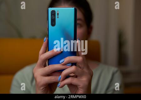 Woman is using smartphone, writing a message, browsing social networks. Technologies for life and work. Stock Photo