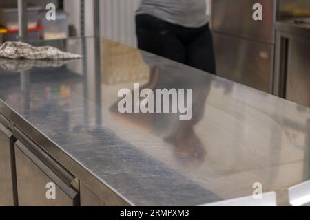 clean stainless steel counter in professional kitchen - hygiene concept Stock Photo