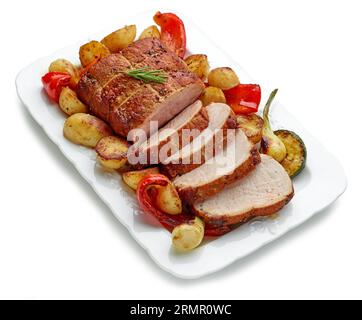 sliced roast pork with vegetables on white plate isolated on white background Stock Photo