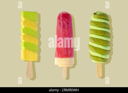 set of various colorful popsicles on green background, top view Stock Photo