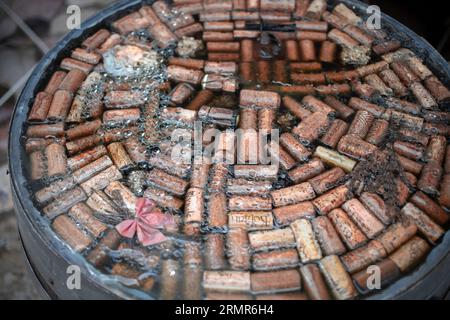 A barrel filled to the brim with rainwater and wine corks Stock Photo