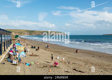 People enjoying sunshine on Aberdaron beach, Llyn Peninsula Gwynedd, Wales Stock Photo
