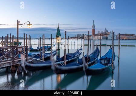 Gondolas in front of San Giorgio Maggiore in Venice at dawn Stock Photo