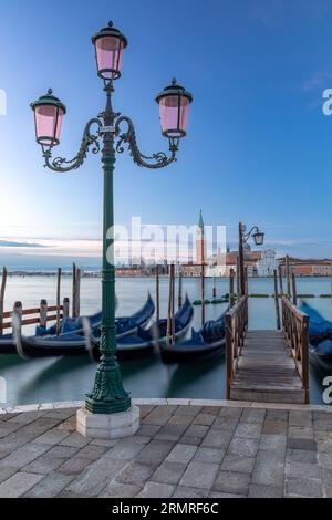 Gondolas in front of San Giorgio Maggiore in Venice at dawn Stock Photo