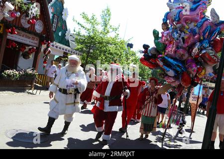 (140723) -- COPENHAGEN, July 23, 2014 (Xinhua) -- Santas walk in Bakken amusement park in Copenhagen, Denmark, during the annual World Santa Claus Congress , on July 23, 2014. The three-day World Santa Claus Congress closed on Wednesday with the participation of over 150 Santa Claus performers from around the world. (Xinhua/Wu Bo) DENMARK-COPENHAGEN-SANTAS PUBLICATIONxNOTxINxCHN   Copenhagen July 23 2014 XINHUA Santas Walk in Bakken Amusement Park in Copenhagen Denmark during The Annual World Santa Claus Congress ON July 23 2014 The Three Day World Santa Claus Congress Closed ON Wednesday With Stock Photo