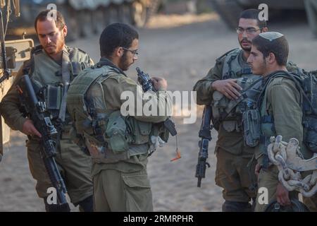 GAZA BORDER, July 30, 2014 -- Israeli soldiers from the Golani Brigade are seen at a staging area before entering Gaza from Israel, on July 30, 2014. Israeli Prime Minister Benjamin Netanyahu said on Thursday that Israel will continue to uproot underground tunnels in Gaza regardless of any possible cease-fire agreement. ) GAZA-ISRAEL-SOLDIERS JINI PUBLICATIONxNOTxINxCHN   Gaza Border July 30 2014 Israeli Soldiers from The Golani Brigade are Lakes AT a Staging Area Before ENTERING Gaza from Israel ON July 30 2014 Israeli Prime Ministers Benjamin Netanyahu Said ON Thursday Thatcher Israel will c Stock Photo