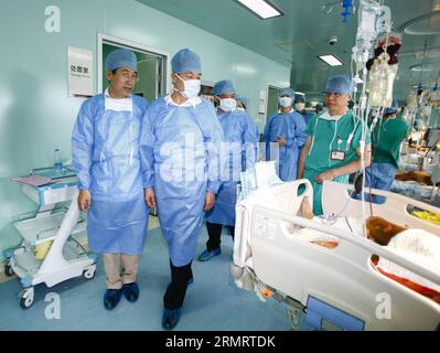 (140803) -- KUNSHAN, Aug. 3, 2014 -- Chinese State Councilor Wang Yong (2nd L) visits people injured in a blast accident at the Third People s Hospital in Wuxi City, east China s Jiangsu Province, Aug. 3, 2014. A powerful factory blast has killed 69 people and injured over 180 others in Kunshan on Saturday morning. The injured have been treated in hospitals in Kunshan and the nearby cities of Suzhou, Wuxi and Shanghai. Wang visited victims of the accident and medical staff members at hospitals in Wuxi, Changzhou and Nantong on Sunday. ) (wjq) CHINA-JIANGSU-KUNSHAN-FACTORY BLAST-WANG YONG (CN) Stock Photo