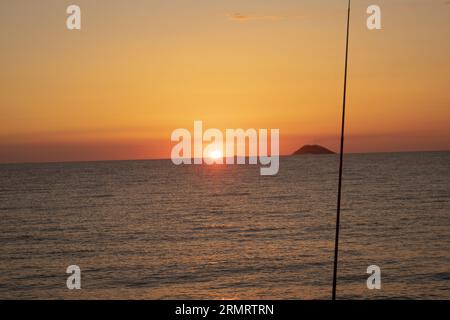 sunset over the aeolian islands seen from calabria Stock Photo