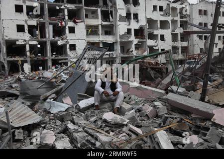 (140804) -- GAZA STRIP, Aug. 4, 2014 -- A Palestinian man on debris of his house destroyed by Israeli military forces in the northern Gaza Strip town of Beit Lahiya, on Aug. 4, 2014. Since the beginning of the Israeli offensive on the Gaza Strip, 1,868 Palestinians have been killed and more than 9470 wounded, said Ashraf al-Qedra, spokesman of the health ministry in Gaza. ) MIDEAST-GAZA-ISRAEL-CEASEFIRE WissamxNassar PUBLICATIONxNOTxINxCHN   Gaza Strip Aug 4 2014 a PALESTINIAN Man ON debris of His House destroyed by Israeli Military Forces in The Northern Gaza Strip Town of Beit Lahiya ON Aug Stock Photo