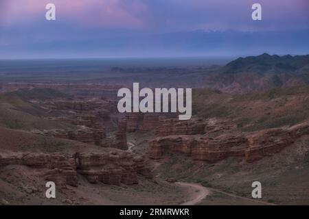 Canyon of the Charyn River in Kazakhstan, Beautiful view of clay rocks and the road to the gorge at sunset. evening Valley of Castles Stock Photo
