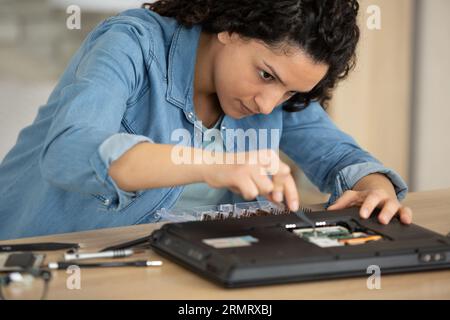 female engineer is focused on the repair of electronic equipment Stock Photo