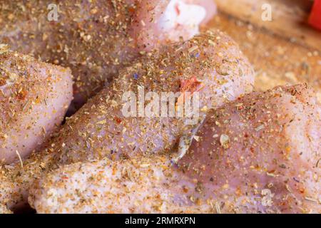 Freshly washed and skinned chicken meat, chicken legs with salt and spices ready for cooking Stock Photo