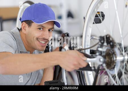 bearded man screws the pedals on the mtb bicycle Stock Photo