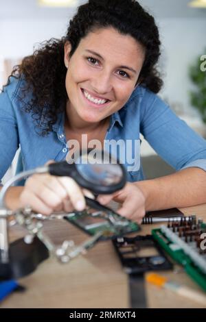 woman repairing computer part in service center Stock Photo