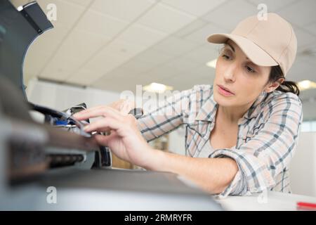 female technician repairing electrical appliance Stock Photo