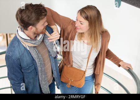 attractive couple of man and woman going on stairs Stock Photo