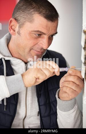 man doing electrical repairs at home Stock Photo