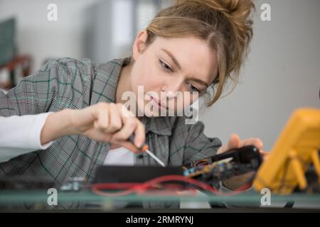 a woman pluging the wire Stock Photo
