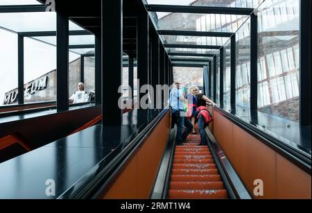 (230830) -- FRANKFURT, Aug. 30, 2023 (Xinhua) -- People take an escalator transformed from a coal conveyor belt at the Ruhr Museum in the Zollverein coal mine industrial complex in Essen, Germany, Aug. 16, 2023.  From the Ruhr area in Germany to the Shougang industrial park in Beijing, one after another steel 'giants' stand as witnesses to the development process of human civilization.     The Ruhr area in Germany is a significant industrial zone in Europe, once a coal and steel production hub for Germany. The Zollverein coal mine industrial complex in Essen was one of the world's largest coal Stock Photo