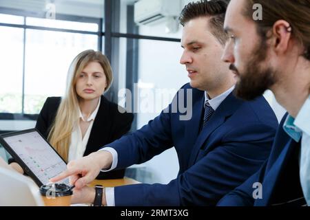 young investor businessmen and business woman team meeting to analysis risk and profit opportunity investment in international stock market. Business Stock Photo