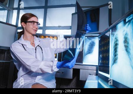 Female medical radiologist doctor looking head and brain x-ray film before surgery in lab office at hospital. Healthcare and education. Stock Photo