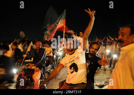 ISLAMABAD, Aug. 15, 2014 -- Pakistani supporters of the opposition Pakistan Tehreek-e-Insaf (PTI) party arrive in Islamabad, capital of Pakistan, Aug. 15, 2014. Thousands of participants in two anti-government marches entered the Pakistani capital of Islamabad late Friday to stage sit-in and present demands. ) PAKISTAN-ISLAMABAD-PROTEST-MARCH AhmadxKamal PUBLICATIONxNOTxINxCHN   Islamabad Aug 15 2014 Pakistani Supporters of The Opposition Pakistan Tehreek e Insaf PTI Party Arrive in Islamabad Capital of Pakistan Aug 15 2014 thousands of Participants in Two Anti Government Marches entered The P Stock Photo