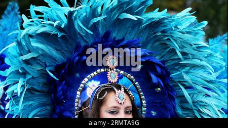 LONDON, Aug. 24, 2014 -- A performer parades through the streets during the Notting Hill Carnival in London, Britain, on August 24, 2014. The Notting Hill Carnival is the largest street festival in Europe and was first held in 1964 by the Afro-Caribbean community. Over the bank holiday weekend, the streets come alive to bands, colourful floats and costumed performers as members of the public flood into the area to join the celebrations. ) UK-LONDON-NOTTING HILL CARNIVAL-CHILDREN S DAY PARADE HanxYan PUBLICATIONxNOTxINxCHN   London Aug 24 2014 a Performer Parades Through The Streets during The Stock Photo