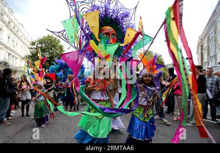 LONDON, Aug. 24, 2014 -- Performers parade through the streets during the Notting Hill Carnival in London, Britain, on August 24, 2014. The Notting Hill Carnival is the largest street festival in Europe and was first held in 1964 by the Afro-Caribbean community. Over the bank holiday weekend, the streets come alive to bands, colourful floats and costumed performers as members of the public flood into the area to join the celebrations. ) UK-LONDON-NOTTING HILL CARNIVAL-CHILDREN S DAY PARADE HanxYan PUBLICATIONxNOTxINxCHN   London Aug 24 2014 Performers Parade Through The Streets during The Nott Stock Photo