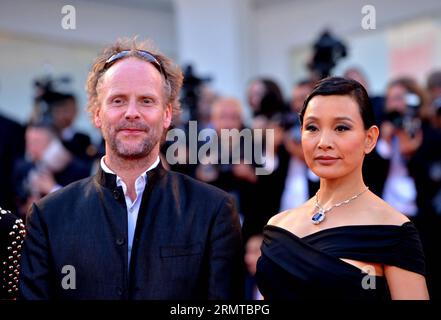 (140827) -- VENICE, Aug. 27, 2014 -- Member of Jury Joan Chen (R) poses on the red carpet during the Birdman premiere and the opening ceremony of the 71st Venice International Film Festival on the Lido island of Venice, Italy, Aug. 27, 2014. The 71st Venice International Film Festival kicked off on Wednesday. ) ITALY-VENICE-FILM FESTIVAL-OPENNING-RED CARPET XuxNizhi PUBLICATIONxNOTxINxCHN   Venice Aug 27 2014 member of Jury Joan Chen r Poses ON The Red Carpet during The Birdman Premiere and The Opening Ceremony of The 71st Venice International Film Festival ON The Lido Iceland of Venice Italy Stock Photo