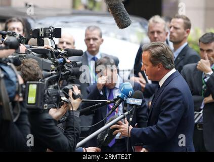 (140830) -- BRUSSELS, Aug. 30, 2014 -- British Prime Minister David Cameron talks to the media while arriving at the European Council headquarters ahead of the European Union (EU) special summit in Brussels, Belgium, August 30, 2014. The support for Ukraine and further sanctions against Russia are expected to top the agenda of the special summit on Saturday. ) BELGIUM-BRUSSELS-EU-UKRAINE-SUMMIT ZhouxLei PUBLICATIONxNOTxINxCHN   Brussels Aug 30 2014 British Prime Ministers David Cameron Talks to The Media while arriving AT The European Council Headquarters Ahead of The European Union EU Special Stock Photo