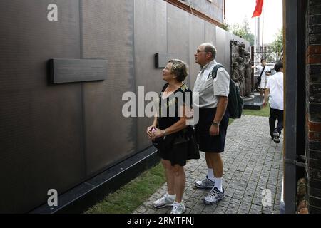 (140902) -- SHANGHAI, Sept. 2, 2014 -- A couple of Jewish descents from the United States view a copper wall at the Shanghai Jewish Refugee Museum, in Shanghai, east China, Sept. 2, 2014. A list naming 13,732 Jewish refugees who took safe haven in China during World War II carved into the 34-meter-long copper wall was unveiled at the museum on Tuesday. Sonja Muehlberger, 75, a German activist who was born into a Jewish family in Shanghai in 1939. Names of her family were also on the list, which originated from the appendix of Exile in Shanghai:1938-1947, a German book exploring the time period Stock Photo